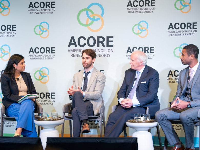Four panelist sitting on stage at the ACORE Finance Forum
