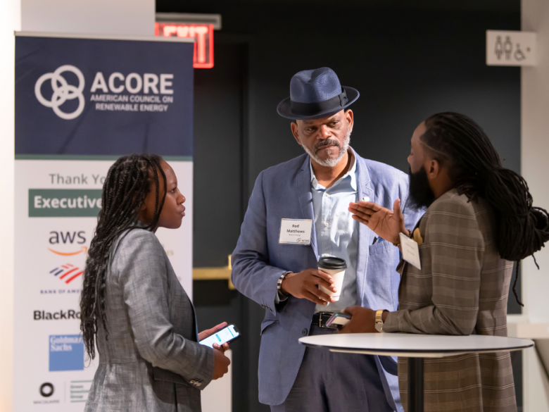 Three Finance Forum attendees networking