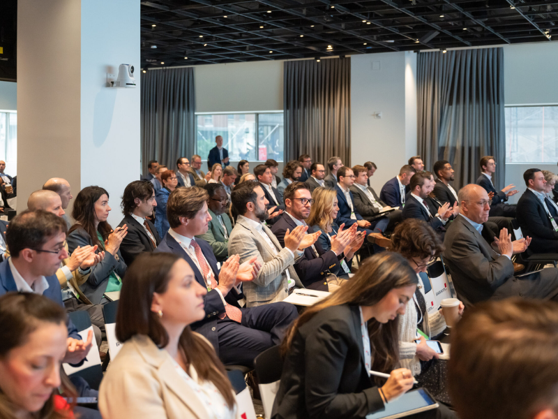 ACORE Finance Forum attendees clapping in the audience.