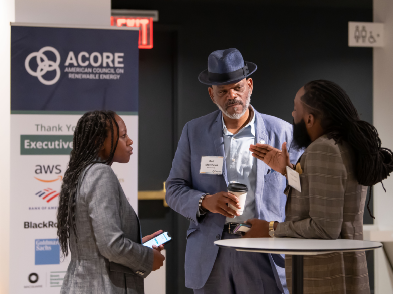 Three Accelerate members network at an ACORE event