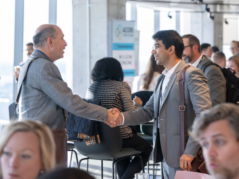 Attendees shaking hands at the ACORE Grid Forum.