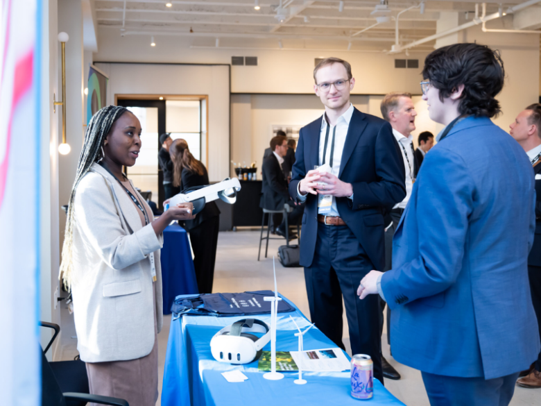 Policy Forum attendees speaking at a booth.