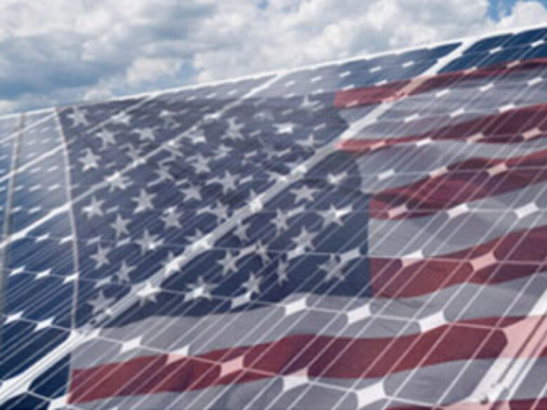 American flag translucent over a solar panel against a sky