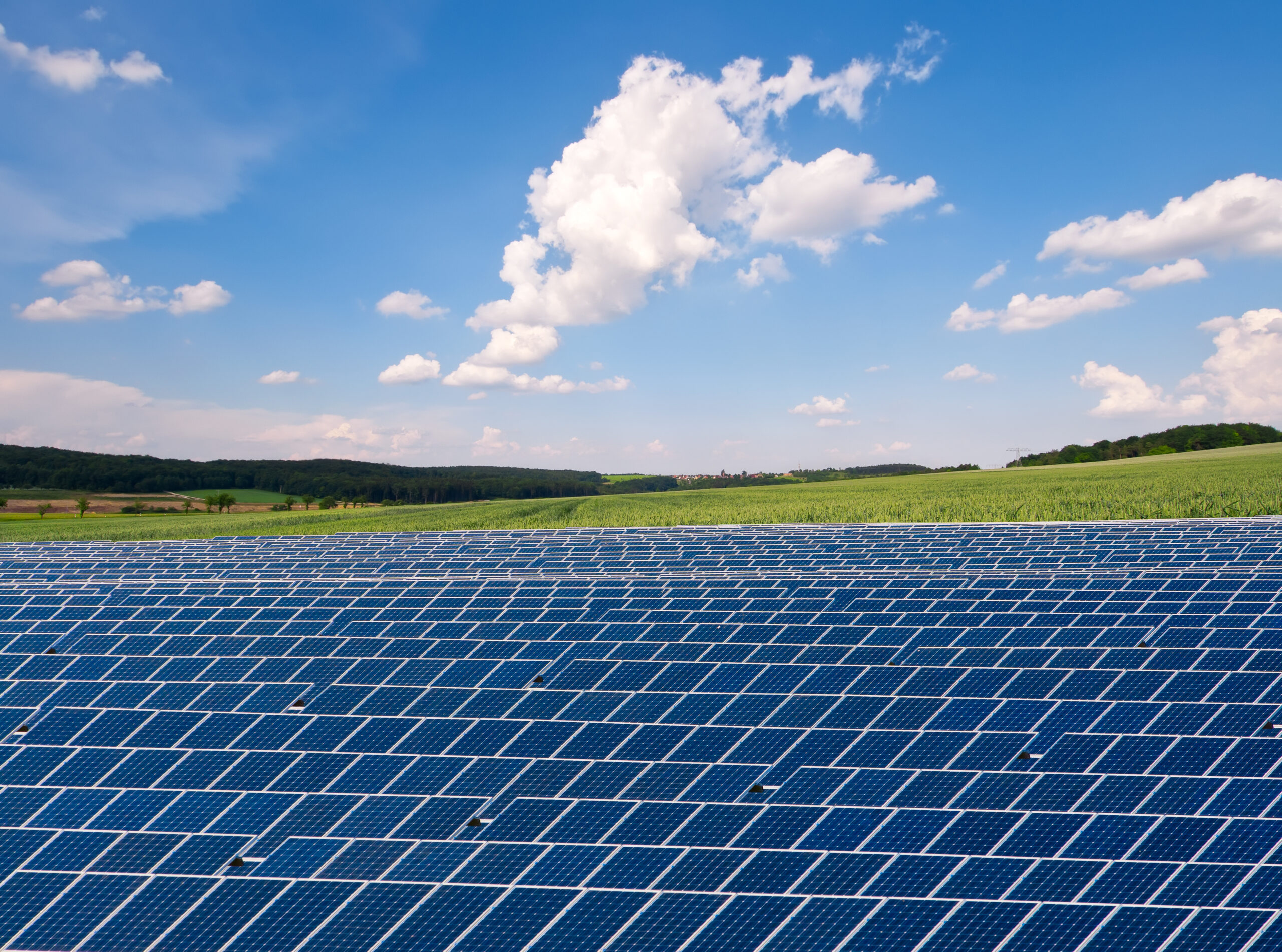 solar panels against a blue sky with white clouds