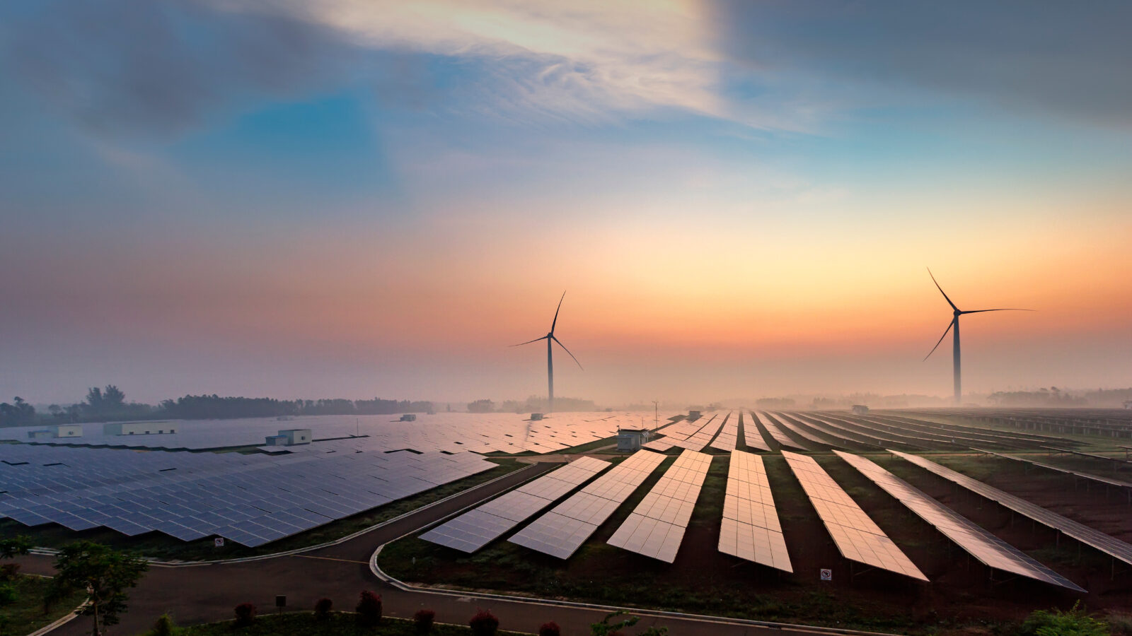 Solar and Wind turbines at sunset