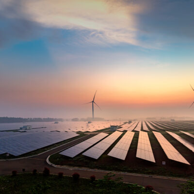 Solar and Wind turbines at sunset