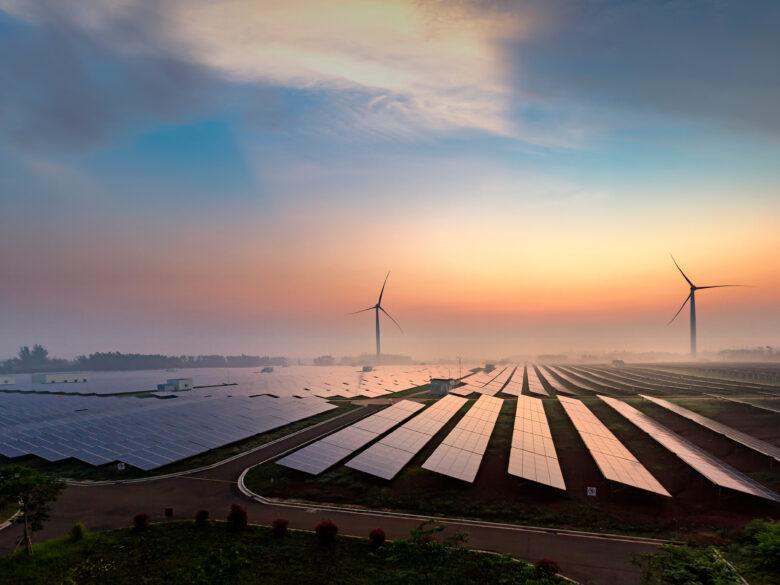Solar and Wind turbines at sunset