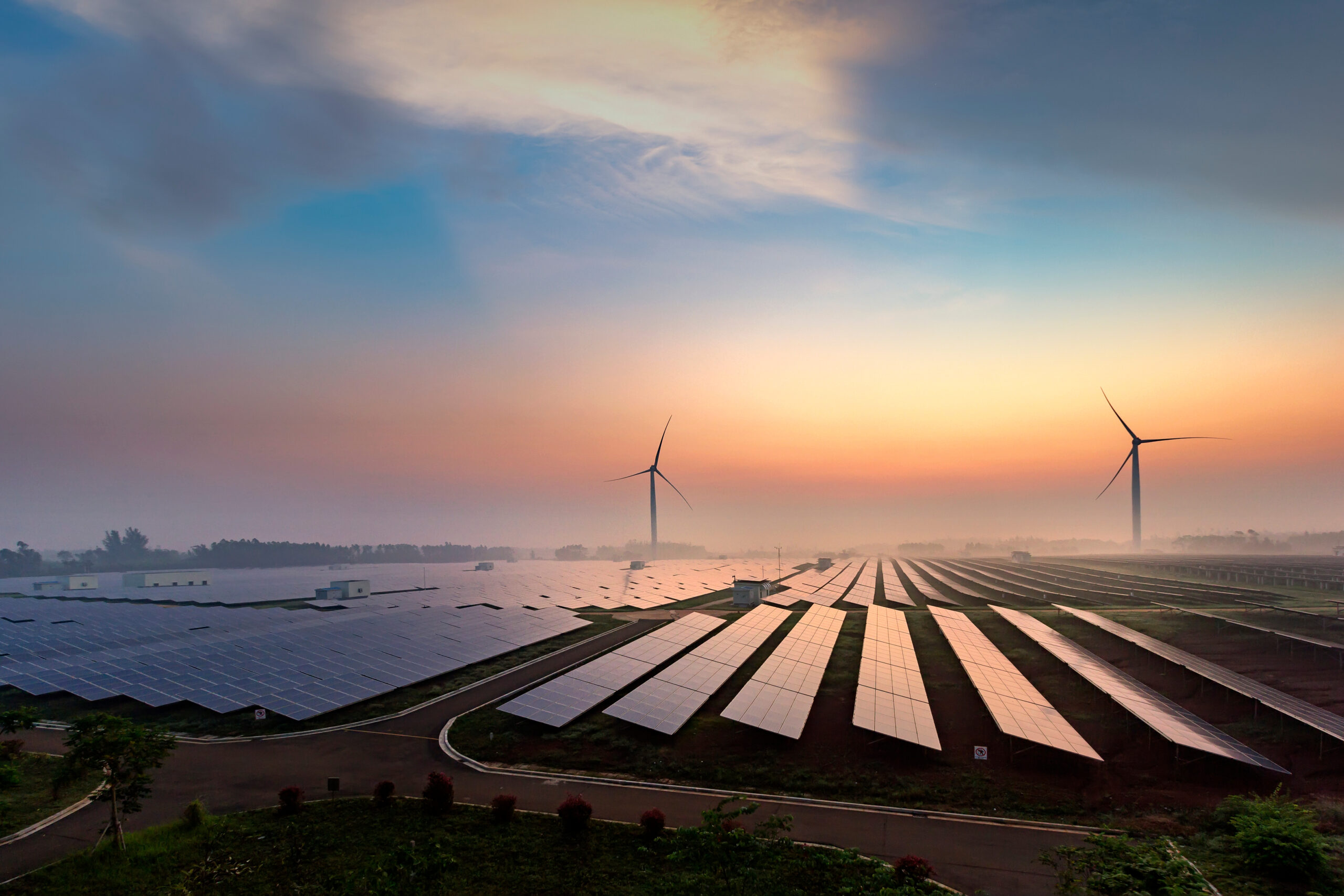 Solar and Wind turbines at sunset
