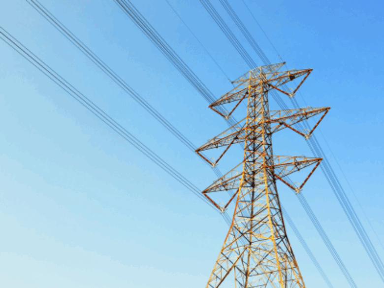 Transmission tower with blue sky in the background.