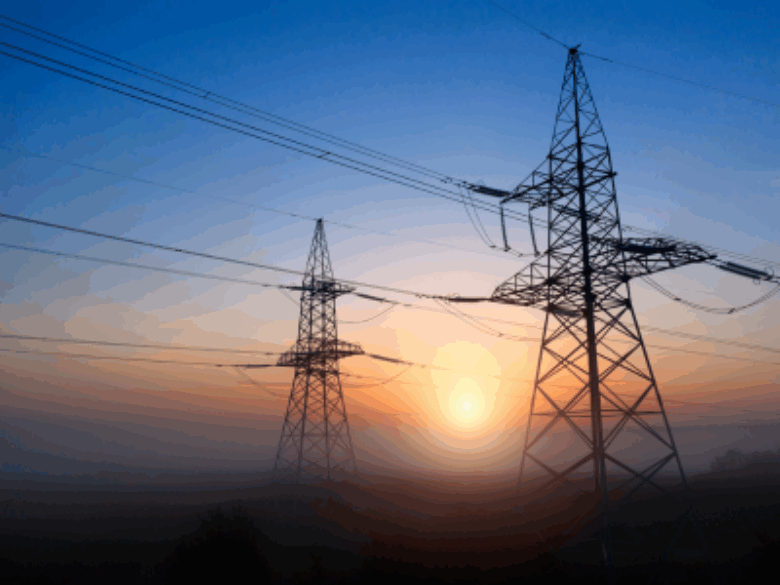 Transmission towers with sunset in the background.