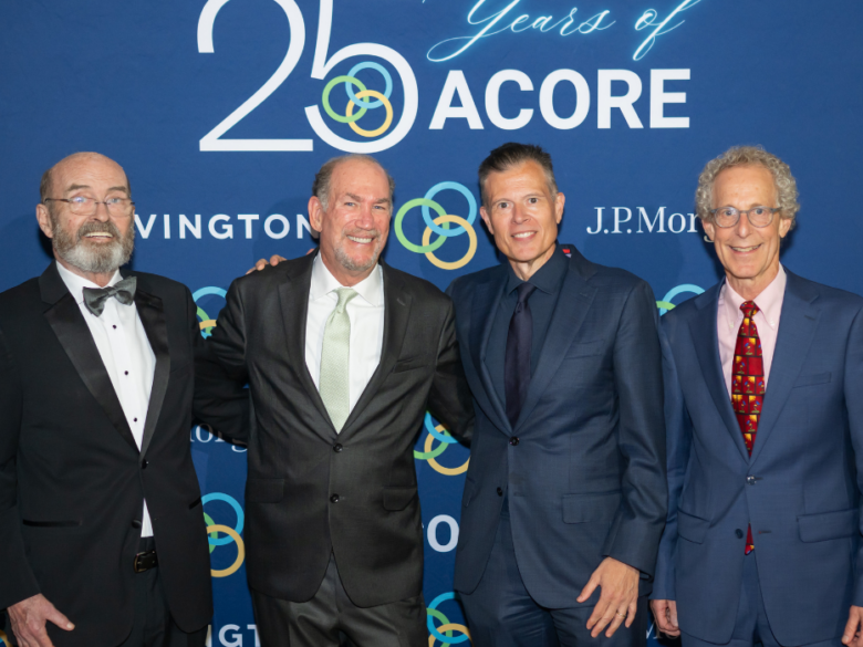 Four attendees pose in front of an ACORE backdrop at the 25th Anniversary Gala.