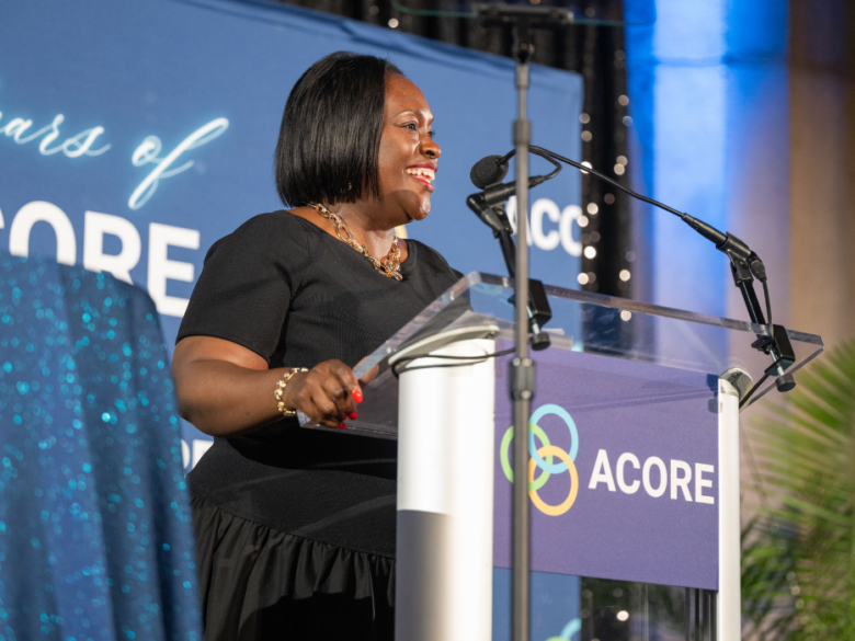 Tonya Hicks addresses attendees on stage at the ACORE Gala.