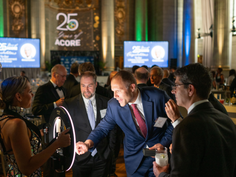 Attendees take a photo at the mobile photo booth at the ACORE Gala.