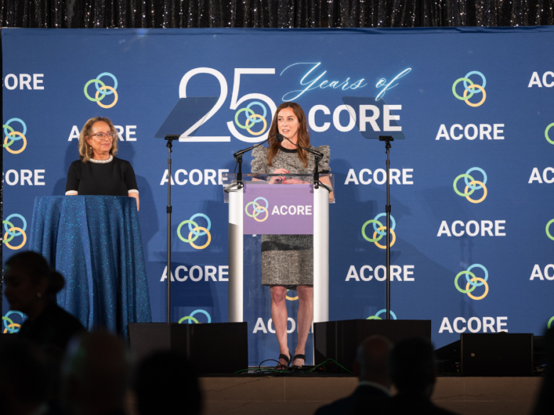Mit Buchanan and Meghan Schultz address attendees on stage at the ACORE Gala.