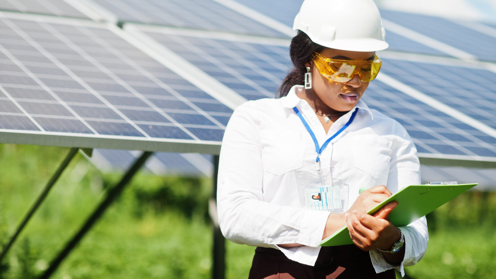 Female technician checks the maintenance of the solar panels.