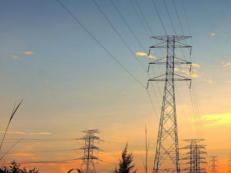 Transmission towers with a sunset background