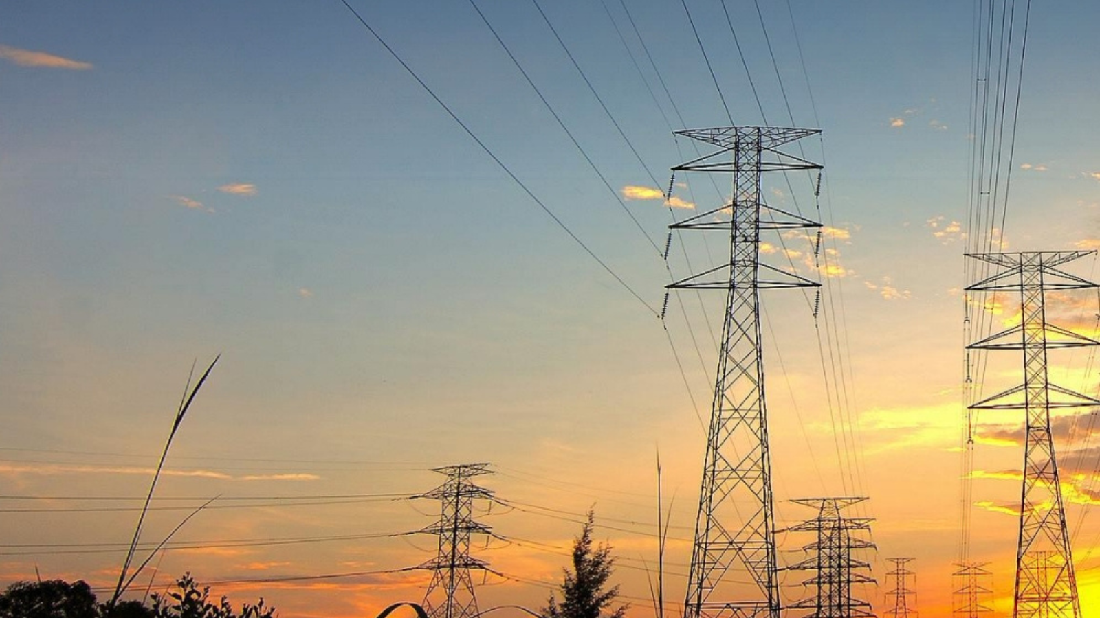 Transmission towers with a sunset background