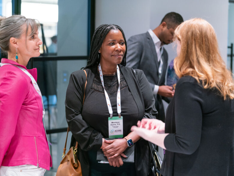 Three attendees networking.
