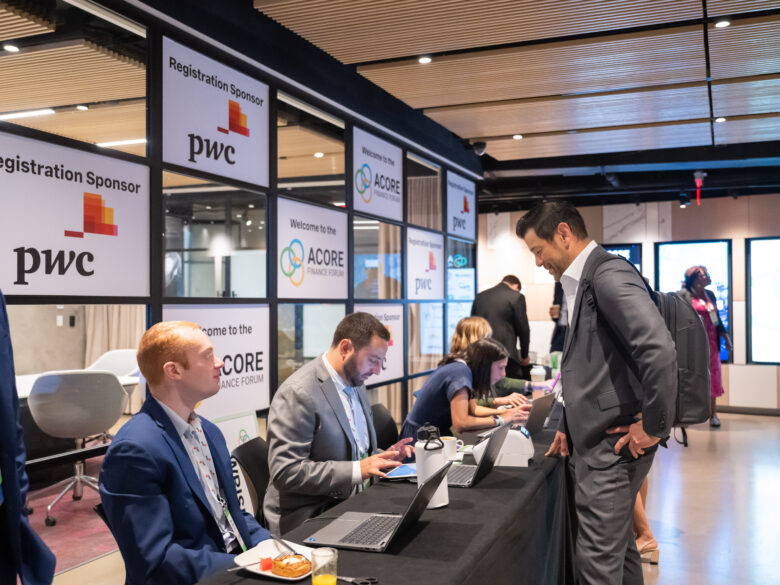 ACORE team checking in attendees at Finance Forum check-in desk.