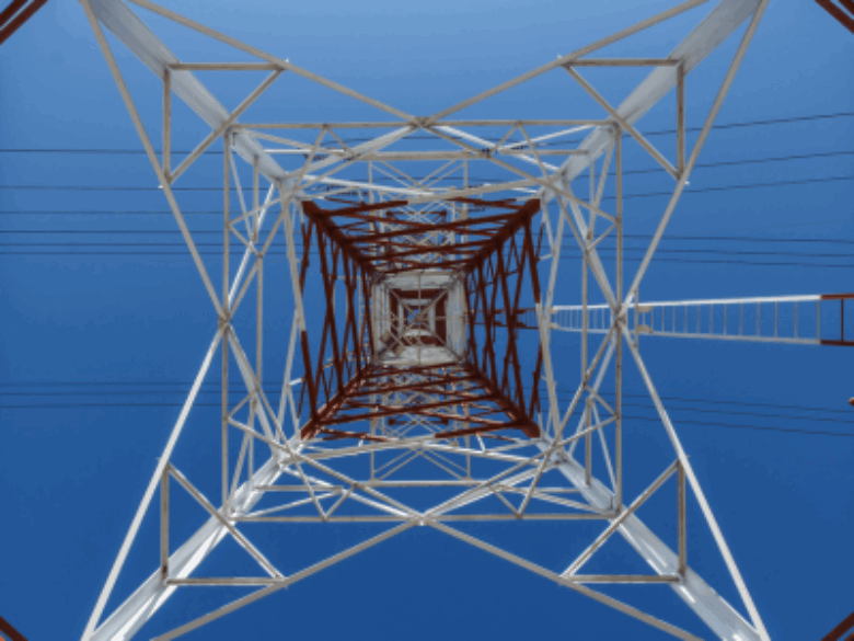 Transmission tower with blue sky in background