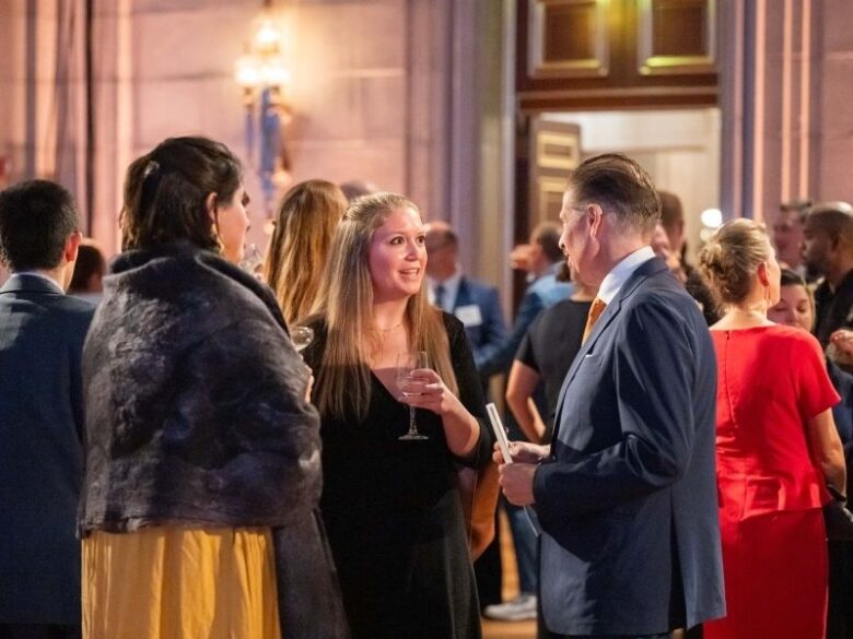 Attendees networking at the ACORE Gala at the Mellon Auditorium.
