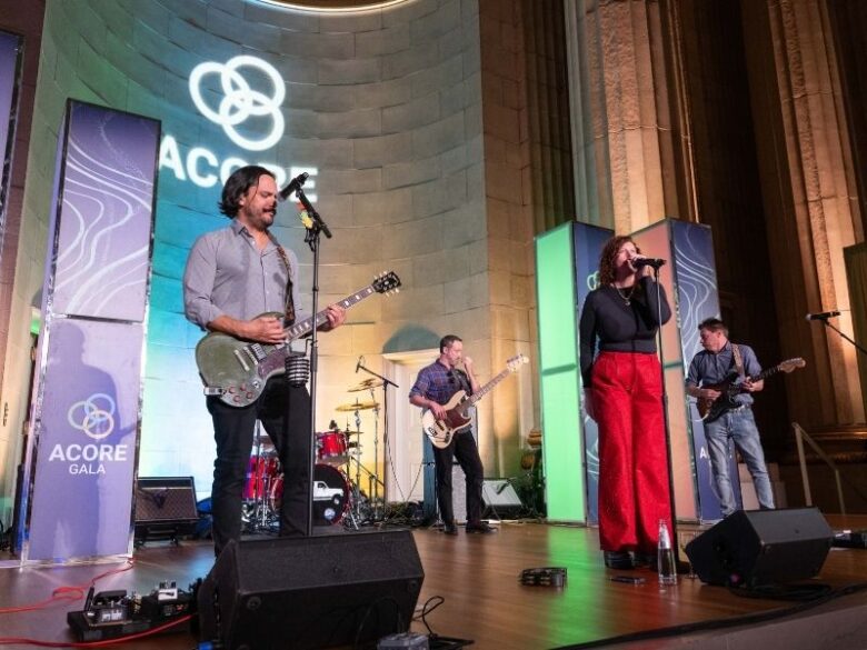 2025 ACORE Gala White Ford Bronco band members sing on stage at the Mellon Auditorium.