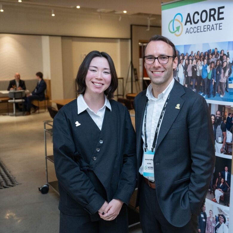Two attendees smiling for a photo at the ACORE Grid Forum.