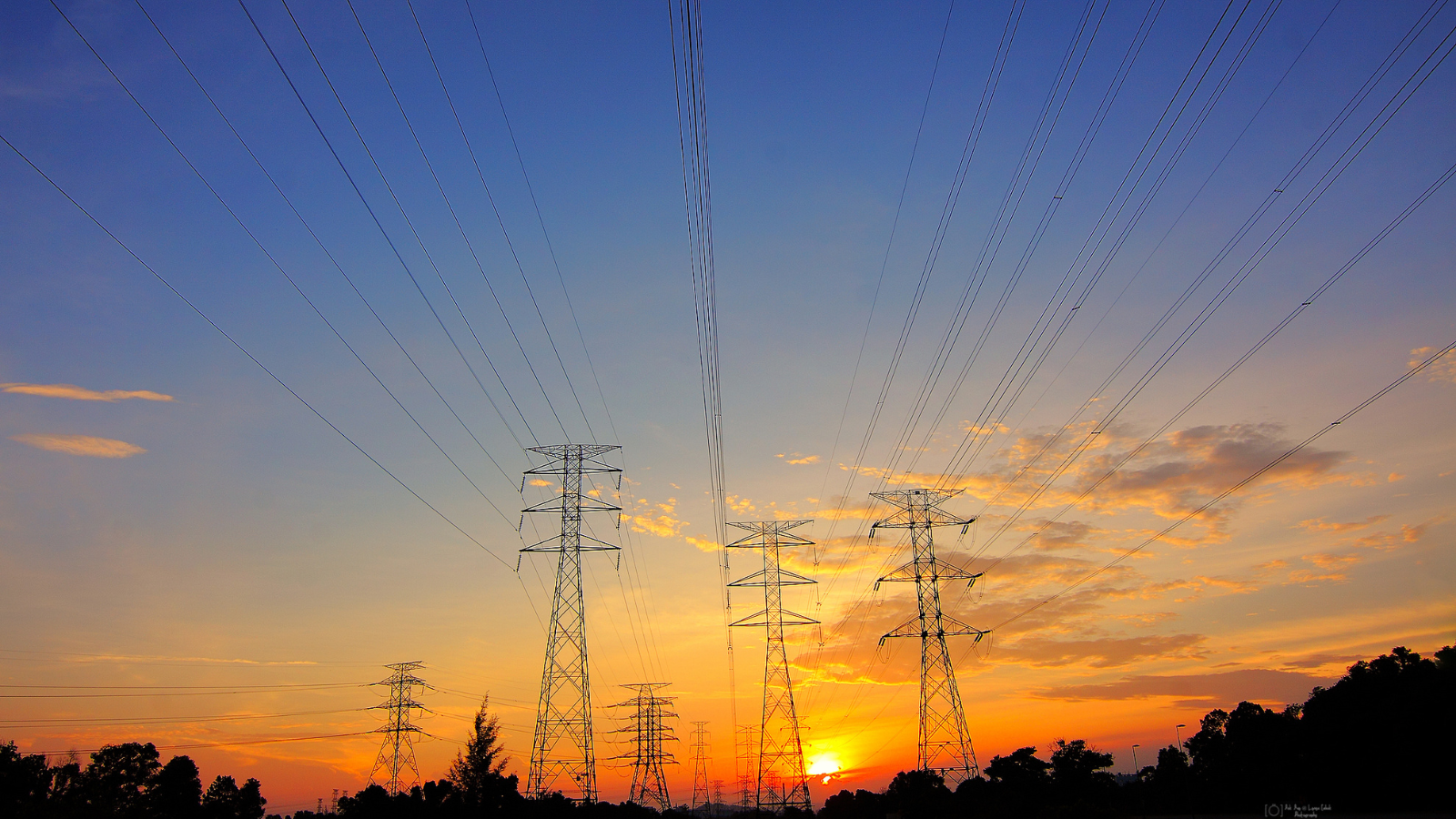 Transmission towers with sunset background.