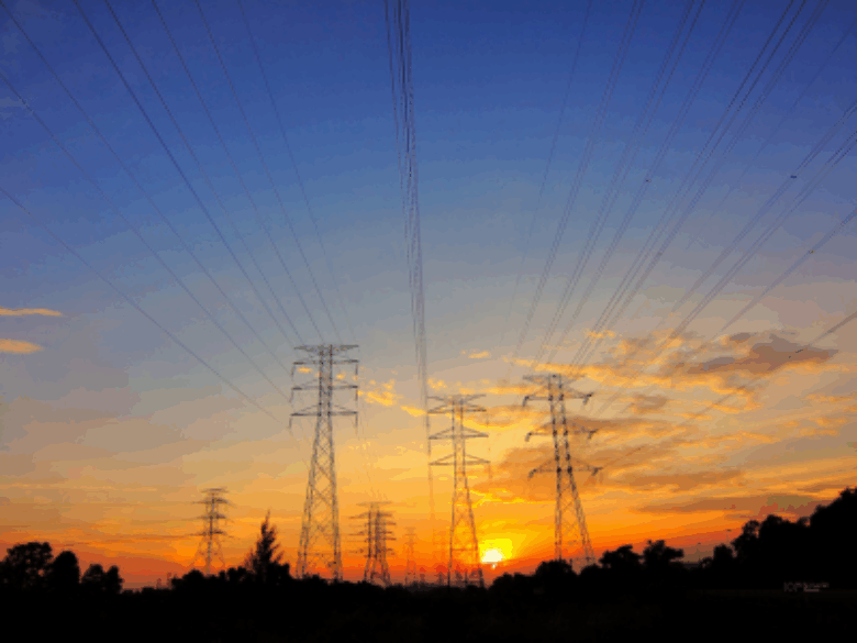 Transmission towers with sunset background.
