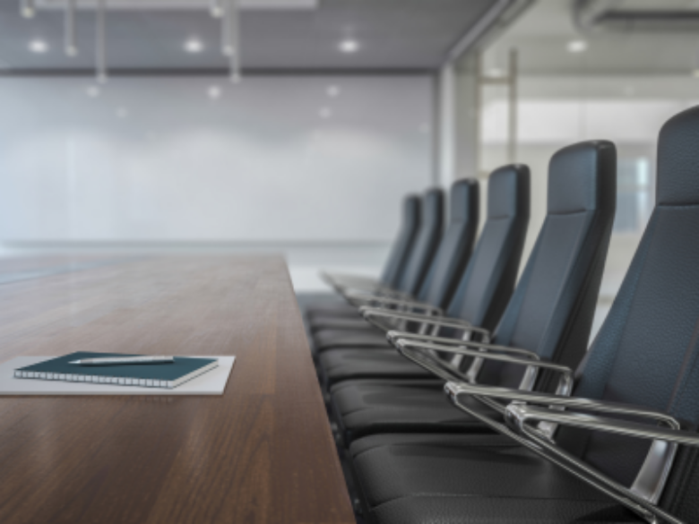 Conference room with large table and chairs.