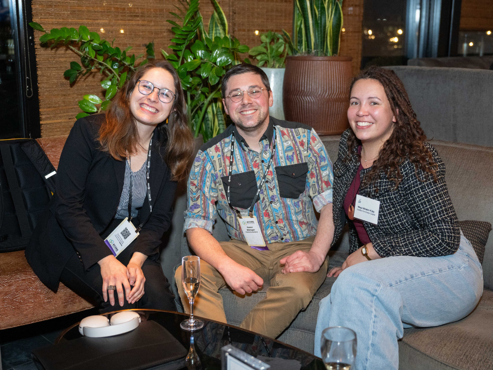 Three attendees smile for a photo at the Accelerate reception.