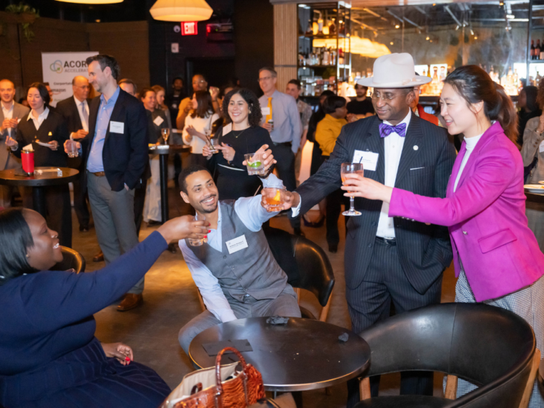 Three event attendees smiling and posing together for a photo booth picture.
