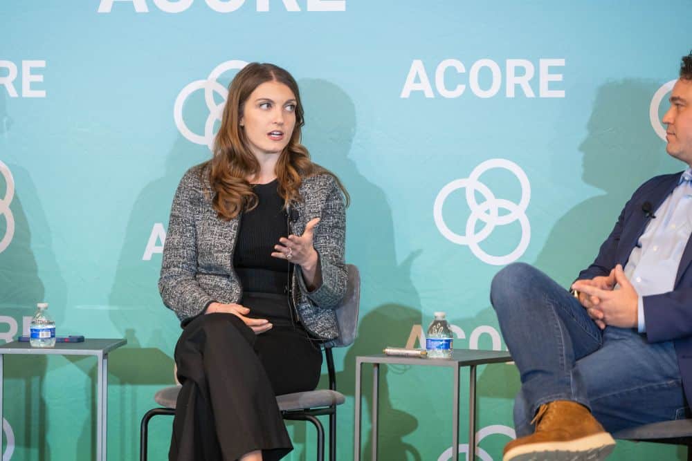Panelist sits on stage and addresses attendees at the ACORE Policy Forum.