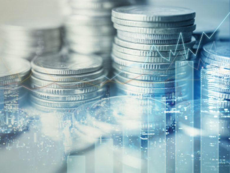 Finance image with coins and charts.