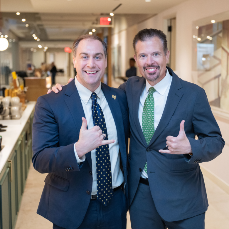 Two ACORE team members smile and pose for a photo.