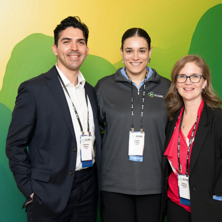 Three ACORE Team members smile for a photo together.