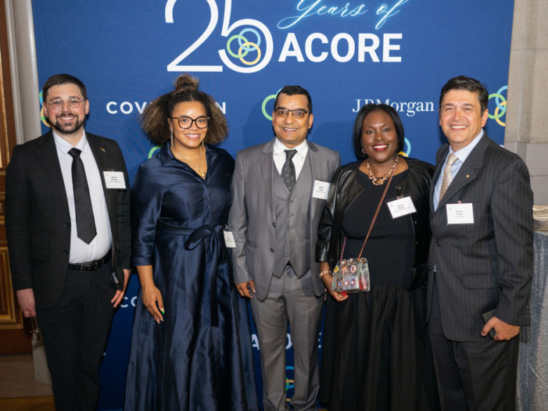 Accelerate members pose in front of a backdrop at the ACORE Gala
