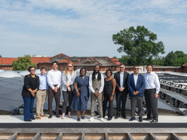 ACORE Accelerate visit to Sycamore & Oak. The group poses on the roof in from of solar panels.