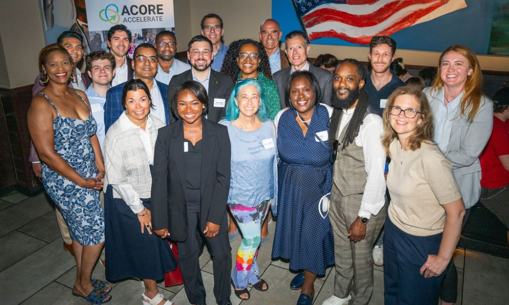 Accelerate Members and Alumni pose for a group photo at a mixer.