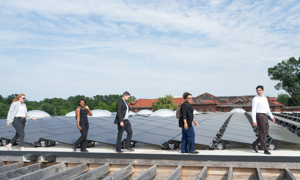 Accelerate members walk at rooftop solar installation at Sycamore and Oak.