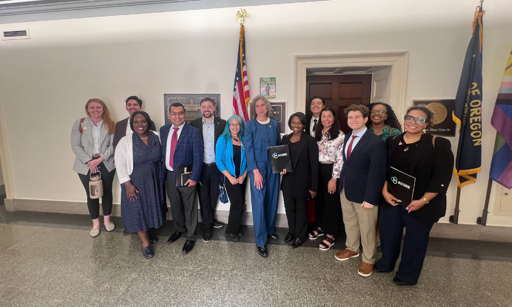 Accelerate members pose for a group photo with Congresswoman Maxine Dexter.