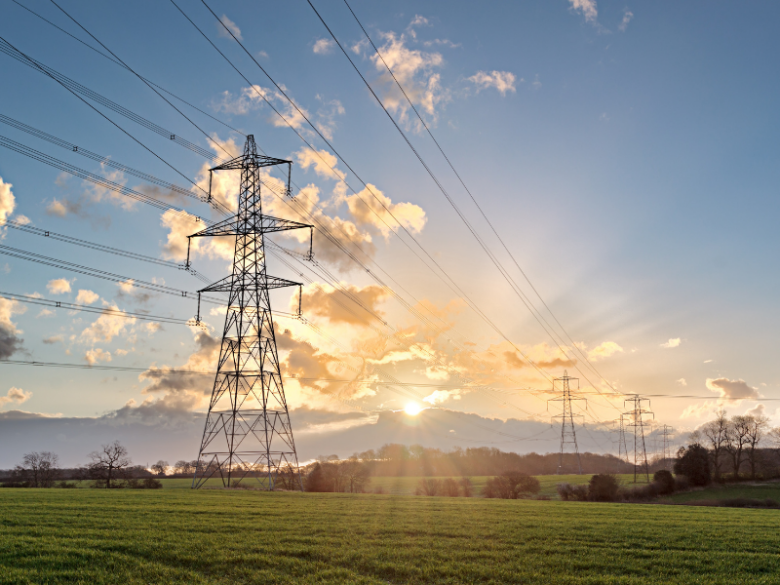 Transmission towers with sunset in background.