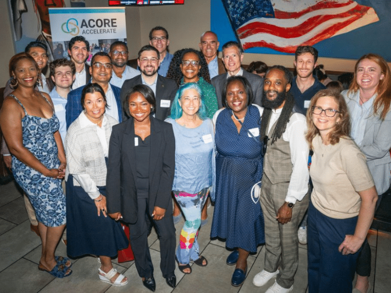 Accelerate Members and Alumni pose for a group photo at a mixer.