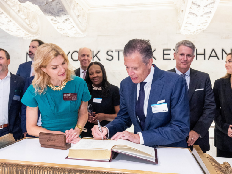 ACORE CEO Ray Long signs a book before the NYSE bell ringing.