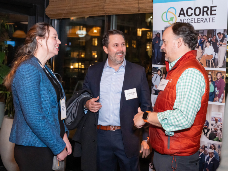 Three clean energy professionals networking at an ACORE Accelerate event.