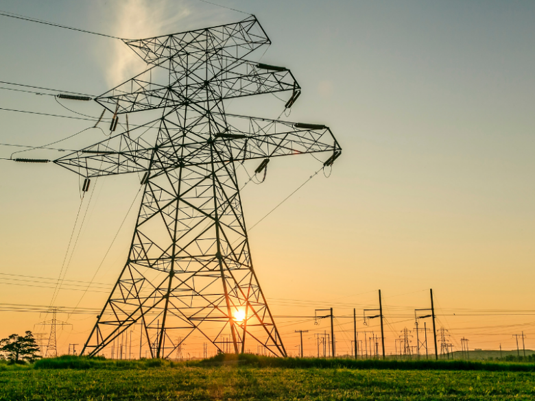 Transmission lines with a sunset background.